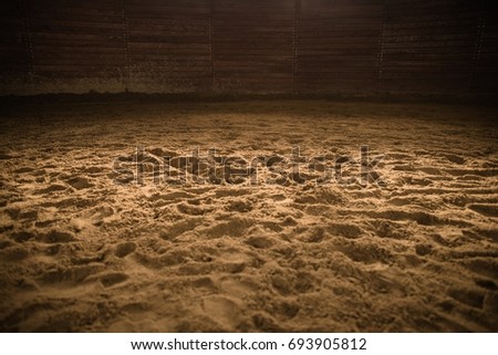 Sandy Horse Riding Arena with Light Spot in the Middle. Rodeo Photo Background. Royalty-Free Stock Photo #693905812