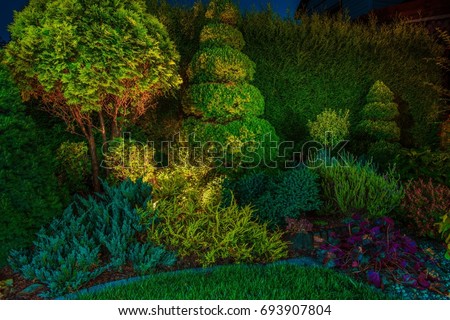 Backyard Garden Led Lighting Illumination. Beautiful Garden Illuminated by Small Spot Light Led Reflectors. Royalty-Free Stock Photo #693907804
