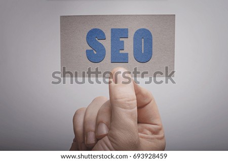 SEO SEARCH ENGINE OPTIMIZATION card in hand. Business concept image.