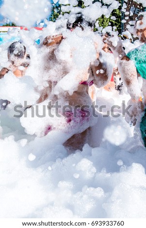 People in foam at a foam party -  A girl in a swimsuit at a foam party