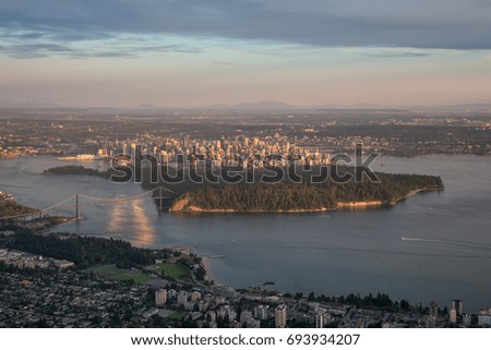 Vancouver Downtown City, British Columbia, Canada. Aerial picture taken during a cloudy summer sunset from an airplane.
