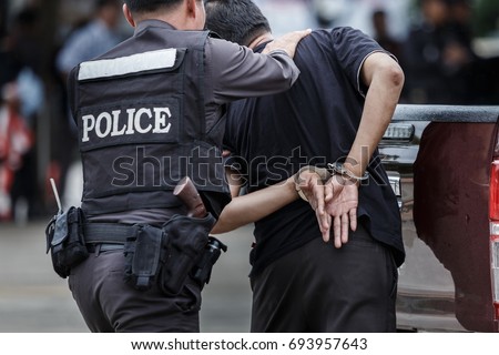 Police steel handcuffs,Police arrested,Professional police officer has to be very strong,Officer Arresting. Royalty-Free Stock Photo #693957643