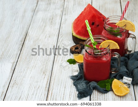 Jars with watermelon smoothie on a table