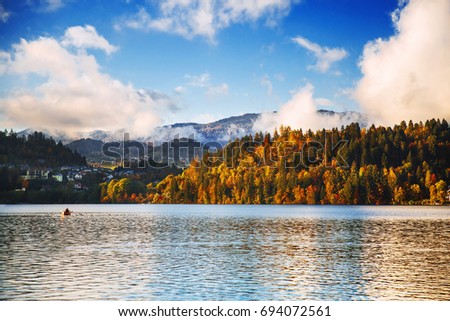 Lake autumn scenery in october. Autumn Lake Bled, Slovenia, Europe. Fall colorful foliage of forest with calm water.
