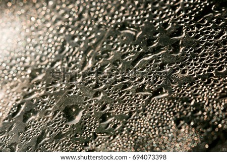 Background of water droplets of condensate on the glass, macro