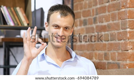 happy businessman or creative male office worker showing ok hand sign