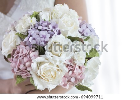 Wedding bouquet in bride's hands, Rich bunch of peony, white roses and hydrangea flower, Focus on white rose, Selective focus.