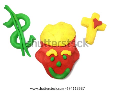 Man face with dollars sign and cross with heart, all objects Bible teaching as cartoon made from kids plasticine, clay oil