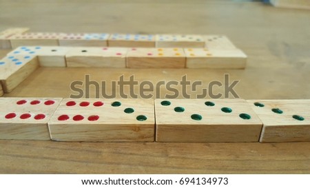 play dominos game wood toy  on the table with family and friend