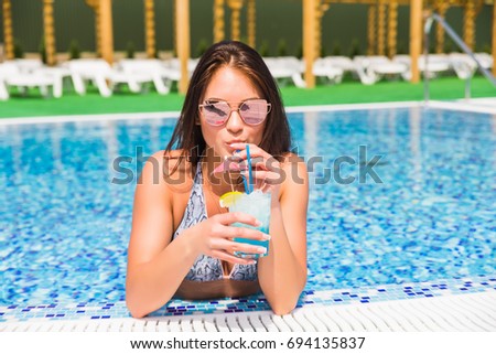Beautiful woman in bikini relaxing in swimming pool
