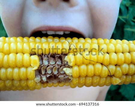 the child eats boiled corn