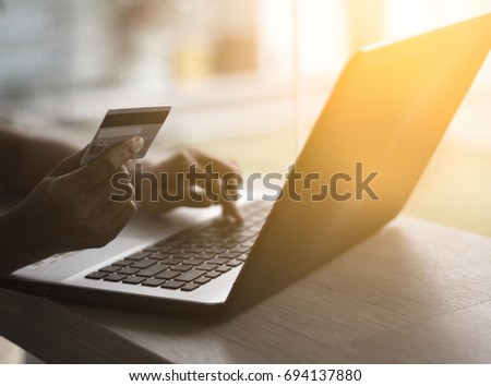 Hands holding credit card and using laptop. Online shopping / soft focus picture / Vintage concept
