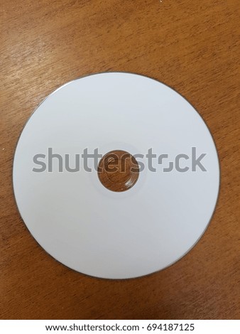 white CD on wooden background