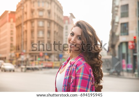 Portrait of carefree girl walking in big city