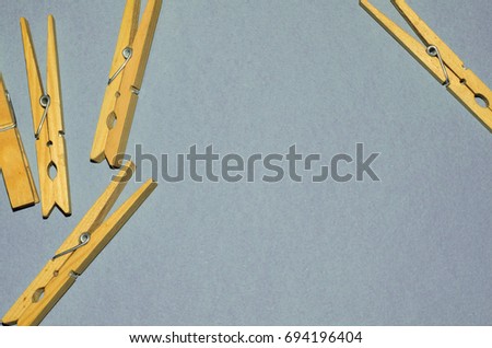 Clothes peg and sheet of blue paper, background