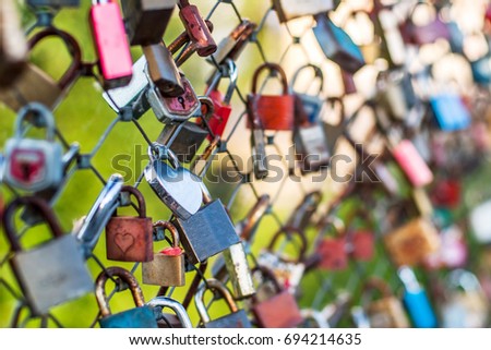 The city bridge with a lot of metal locks. Romantic traditions