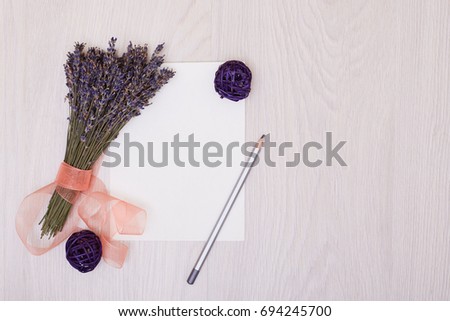 Lavender flowers and empty photo album book cover. Floral frame from dried plants. Flat lay background