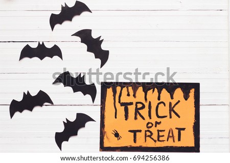 paper origami bats on a gray background, decorations for the holiday Halloween