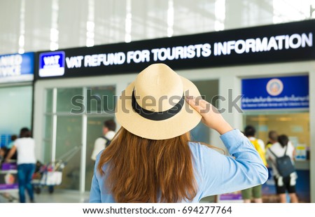 Woman tourist is looking at currency exchange booth at the airport.