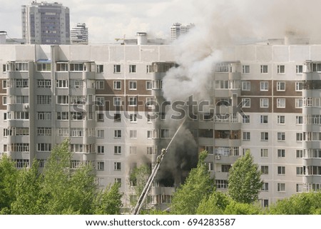 Firefighters extinguish a fire in multistory apartment building