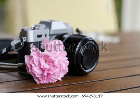 vintage camera on wood and sweet flower