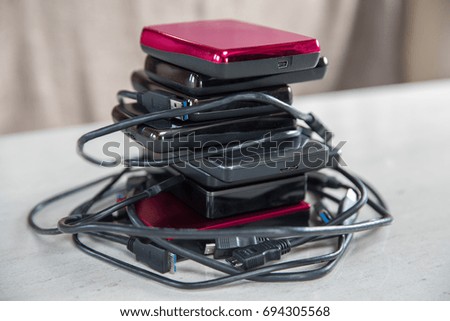 External hard drives with cables around them