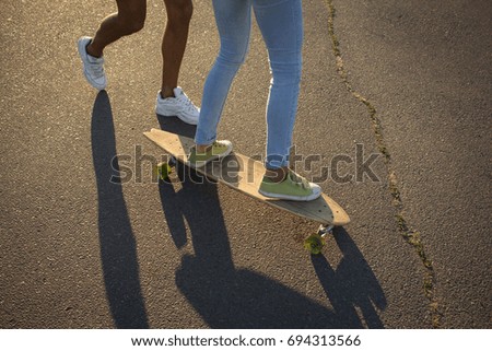 Happy young couple riding on skateboard, concept of happiness, love and youth 