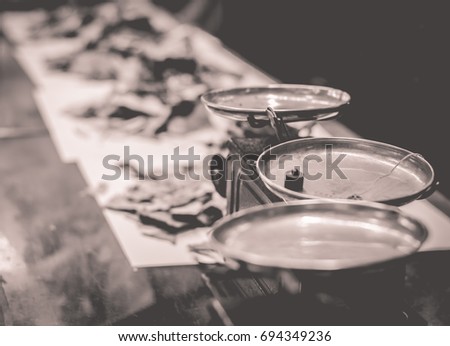 Traditional Chinese medicine shop on black and white or sepia to soft and blur picture, herb ingredients used in alternative herbal medicine with old brass scales.