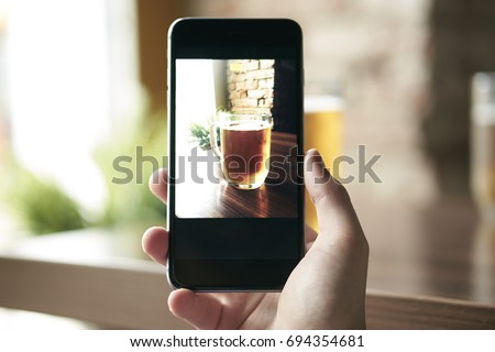 Close-up photo of a man taking a beer cup                                                              