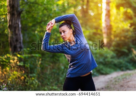 Young beautiful girl doing exercise before training