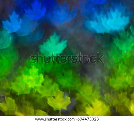 Beautiful background with different colored leaf, abstract background, leaf shapes on black background, blurry