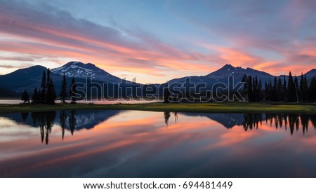 Sparks Lake Summer Sunset South Sister and Broken Top are reflected in Sparks Lake at sunset  Royalty-Free Stock Photo #694481449