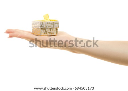 Small gift box in female hand on white background isolation