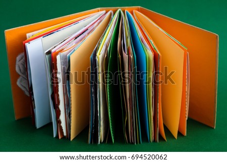 A colorful, handmade junk journal. Made from a recycled box and  random paper such as book pages, envelopes and wall paper. 