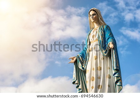 Virgin Mary statue with nice sky background Royalty-Free Stock Photo #694546630