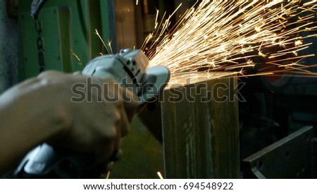 Man cutting iron with hand cutter (soft focus)