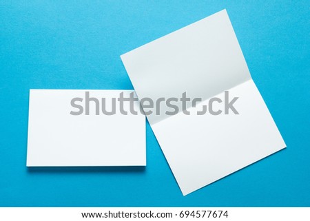 A layout for menus or brochures on a blue background. Two sheet brochures or greeting cards. Mock-up. Royalty-Free Stock Photo #694577674
