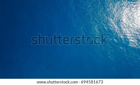 Top down aerial view of a blue ocean Royalty-Free Stock Photo #694581673