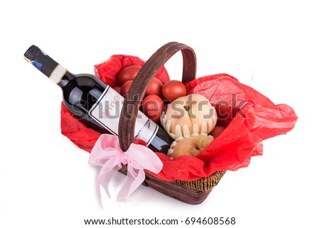 Hamper basket consist red eggs, peach and red wine for good luck