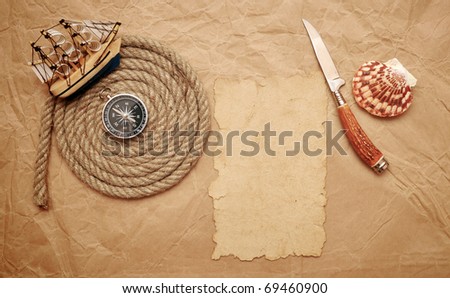  rope coil, decorative knife and model classic boat on old paper