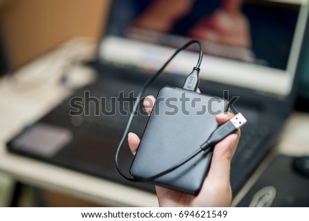 External hard drive for backup in hand Royalty-Free Stock Photo #694621549