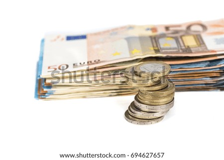 Pile of banknotes bills and pile of coins European currency money