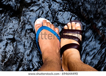two feet in a waterfall. chill out feel in summer