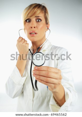 Nurse with the stethoscope in her hand looking scared
