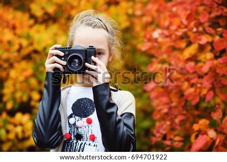 Teen girl taking a shoot with old photo camera