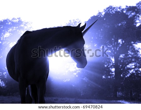 Image of a magical unicorn against hazy sunrise with sun rays Royalty-Free Stock Photo #69470824