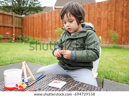 Little boy holding paint brush, Concept for toddler activities with parent or friends                               