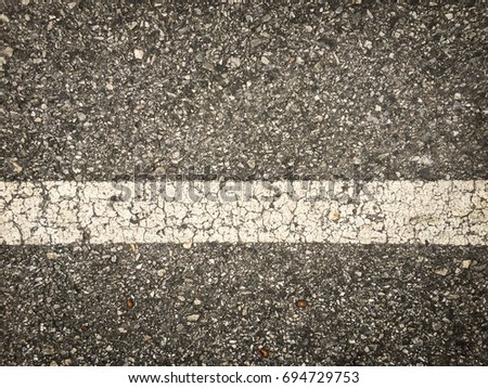 white lines on an asphalt road-narrow depth of field