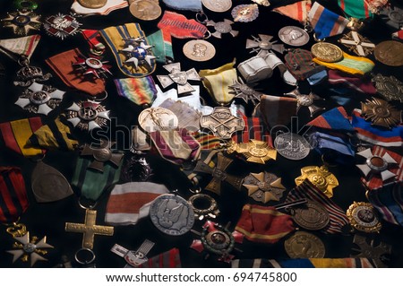 Old retro military orders and war medals on black background. Background of old retro military awards and war medals.