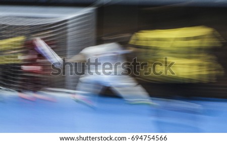 Motion Blur. Panning. Picture with camera made motion blur effect of a futsal match at indoor court.